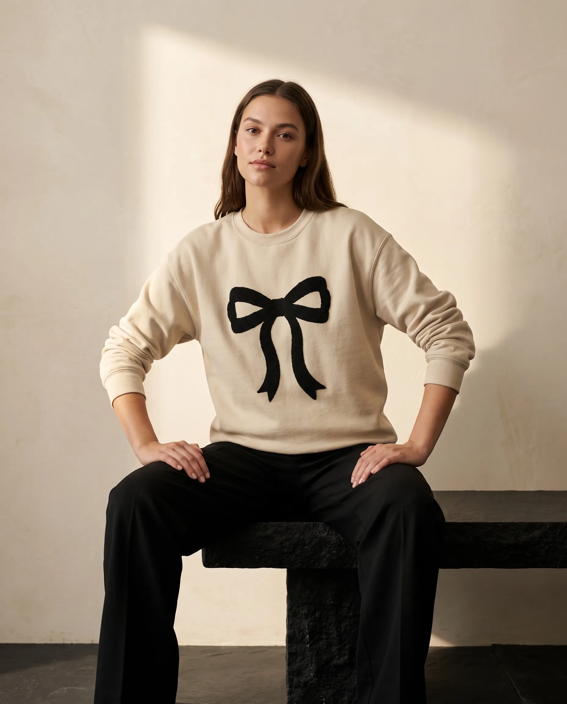 Woman wearing the Graphic Bow sweatshirt from the women’s collection
